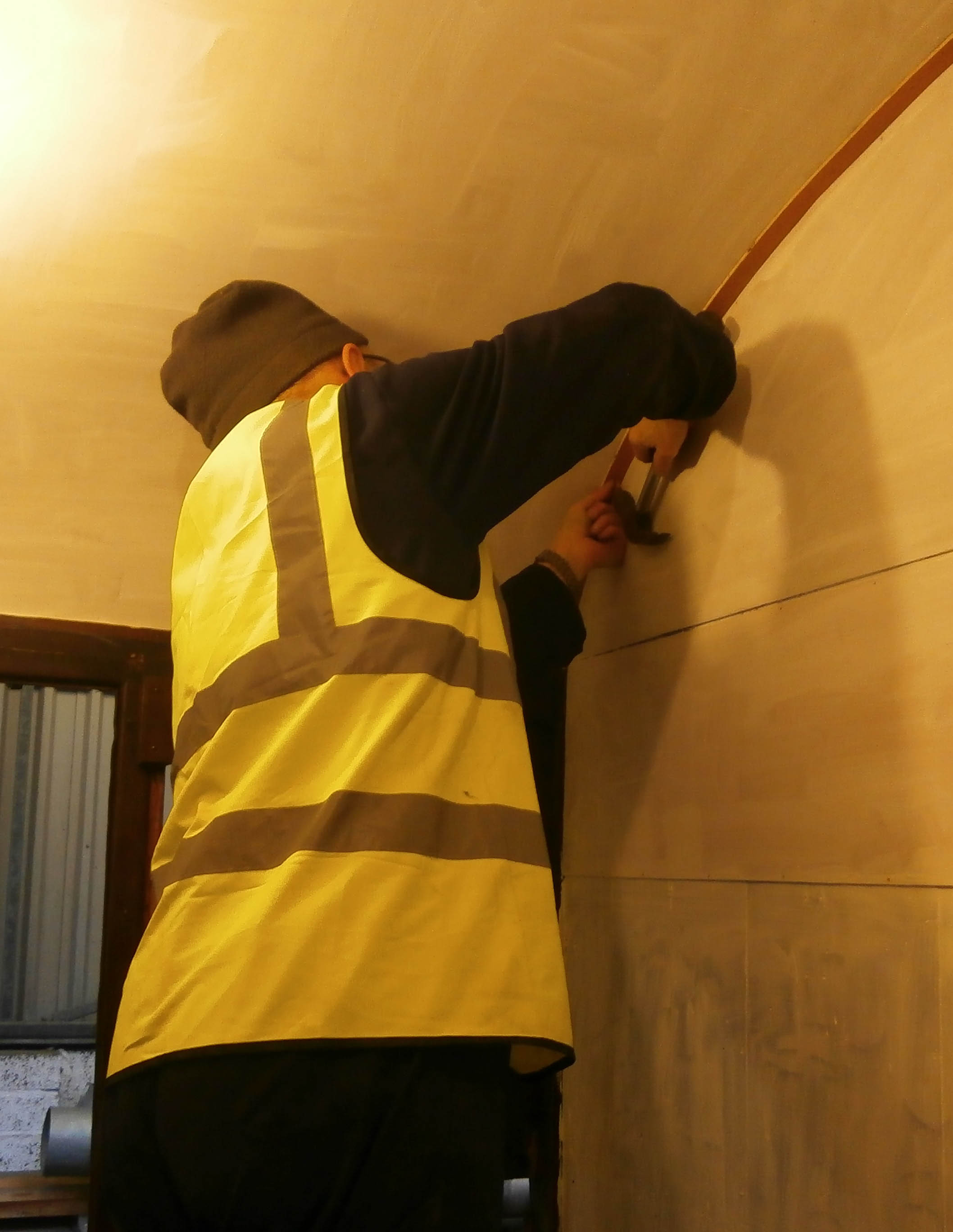 Graham Warren pins up the compartment ceiling edging