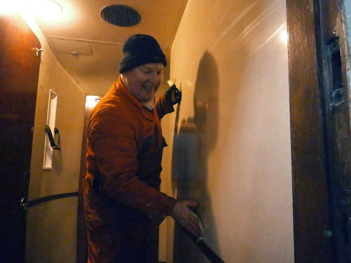 John scraping and cleaning the east vestibule